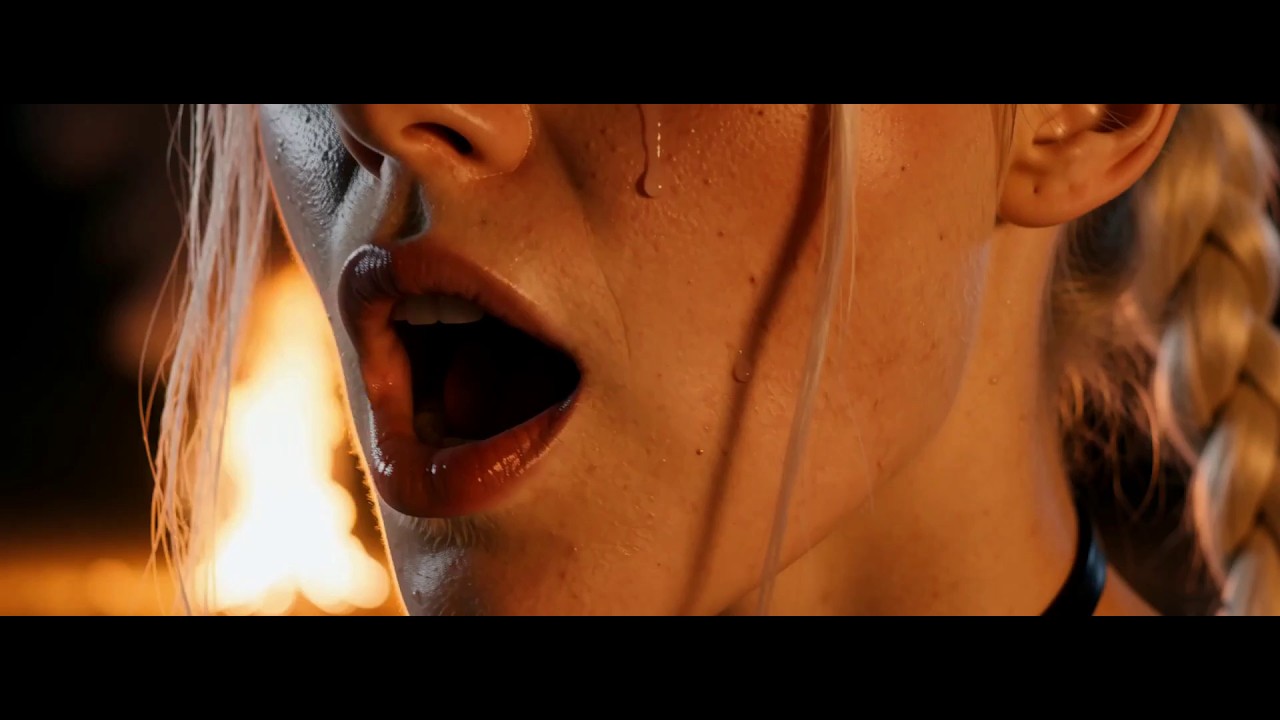 Close-up of the silver-haired Volta lit by fire against a dark background