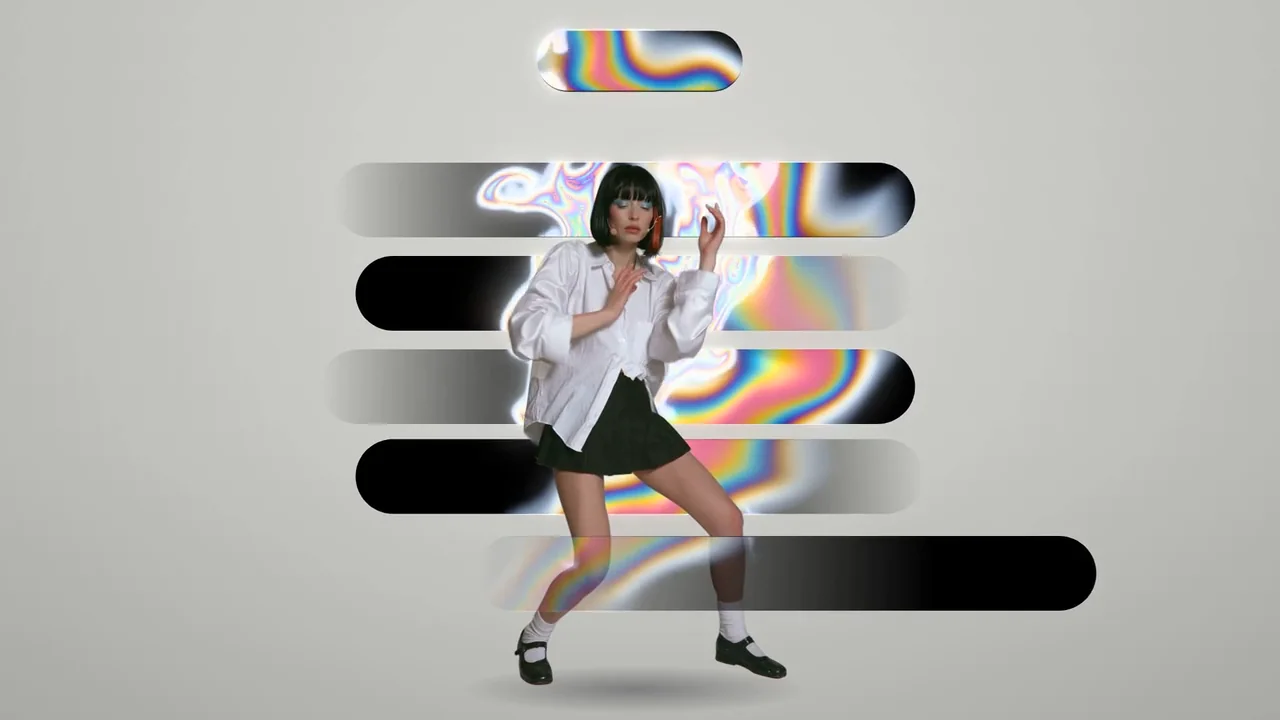 Claudia dances among black pill-shaped windows and iridescent colour on grey paper