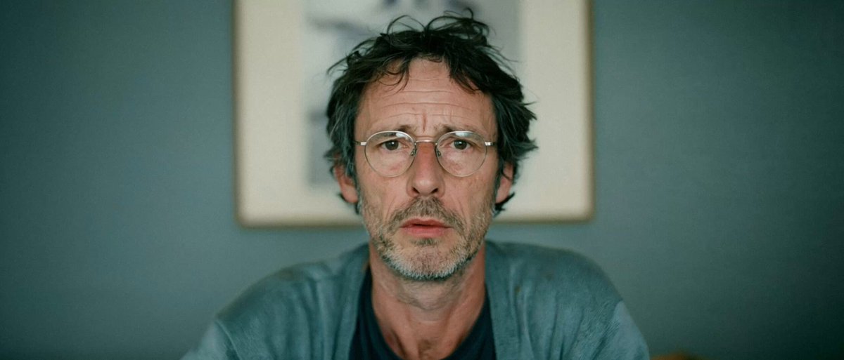 A bespectacled man in the original SPARE release artwork