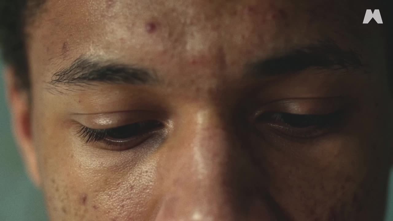 Close-up of a man’s lowered eyes in The Black Box